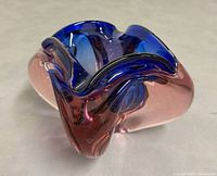 Angled view showing blue and pink thick glass bowl