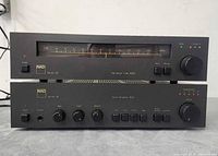 Front view of NAD Series 20 amplifier 3020 stacked under tuner 4020 showing controls and displays