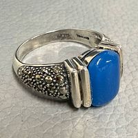 Full view of ring showing blue chalcedony stone, marcasite shoulders, and silver design
