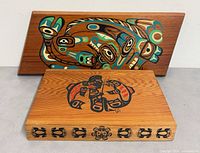 Front view showing both items: box closed displaying lid artwork, plaque front artwork