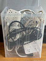 All cords and power bars inside clear bin