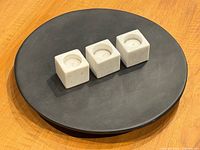Tray with three marble tealight holders centered