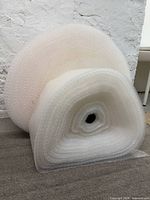 Two rolls of bubble wrap, large behind smaller front