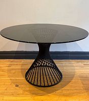 Full view of round glass table showing base and top
