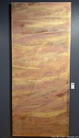 Full view of tall abstract metallic painting on wall