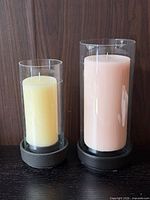 Pair of Stelton hurricane candle holders with candles in place