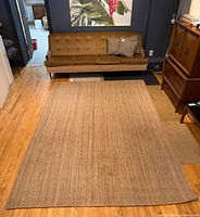 Full top view of jute rug on hardwood floor