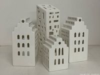 Front view of four ceramic building sculptures