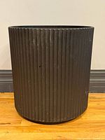 Front view of black ribbed resin planter