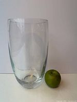 Front view of clear glass vase with apple for scale