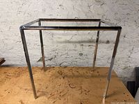 Full view of chrome rectangular frame on workbench
