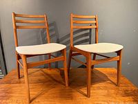 Pair of teak dining chairs front angle