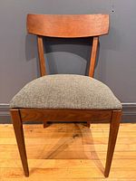 Front view of walnut dining chair, showing backrest and seat