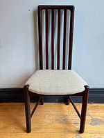 Full view of one chair showing frame design and upholstery