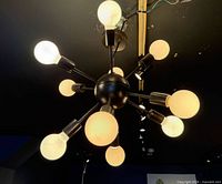Overall view of ceiling-mounted Sputnik fixture illuminated