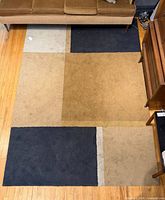 Full view of rug showing entire geometric design and size relative to surrounding furniture