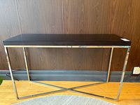 Front view of console table showing metal frame and black top