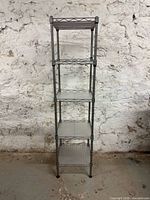 Full view of 5-tier metal shelving unit against wall