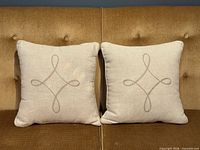 Front view both pillows showing embroidery design