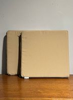 Two beige square cushions front view