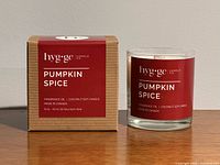 Boxed and unboxed Pumpkin Spice candle side by side