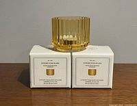 unboxed holder on two boxed holders showing brand and packaging