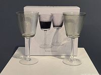 Box with image of three Grand Cru Nouveau glasses and two actual glasses displayed