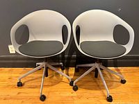 Pair of grey Allermuir Kin swivel armchairs front view