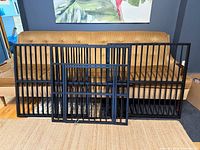 All disassembled crate panels lined against sofa