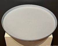 Top view of grey round plastic tray