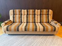 Front view of striped three-seat sofa showing full design and upholstery pattern