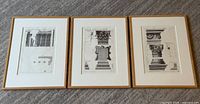 Three framed architectural prints side by side