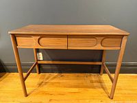 Front view of desk showing overall form and drawer fronts
