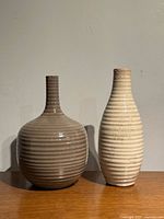 Taupe and cream ribbed glazed vases side by side