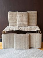 All five cushions and seat cover displayed against wall