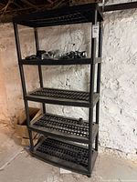 Front view of full shelving unit showing five grid shelves and tubular supports