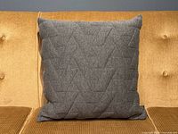 Front view of grey geometric-patterned pillow on sofa