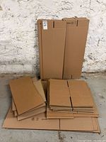 Stack of tall lamp boxes and smaller cartons