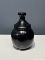 Front view of black soapstone jar with lid fitted
