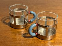 Both espresso mugs angled view showing material and handles