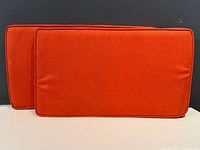 Front view of both orange cushions