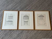 Three framed architectural prints side by side