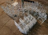 stacked white metal garden fence panels showing quantity