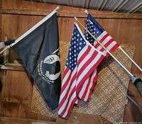 Three flags on poles: POW-MIA and two U.S. flags