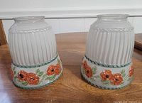 pair of ribbed frosted glass shades with painted floral bands