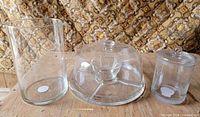 All three clear glass items: vase, snack tray with cover, candy jar