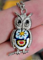front view of owl pendant showing glass inlay colours