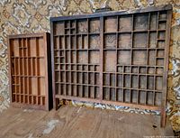 Front view of both wooden display cases showing sizes and compartment layout