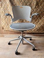 Front view showing mesh seat, perforated back, casters