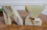 Front view of both marble letters A and Z